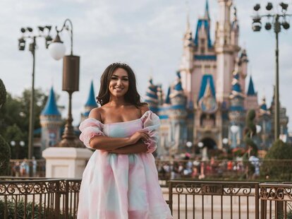 woman with three children in front of epcot globe
