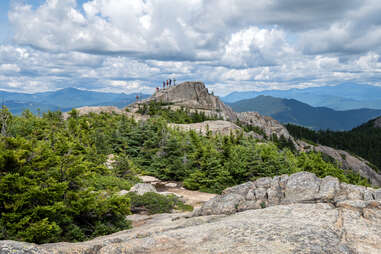 several hikers on Piper Trail as they make their ascent toward Mount Choorua's summit in Albany, New Hampshire.