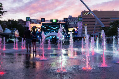 fountains sprouting out of the ground in the evening, in the downtown entertainment district