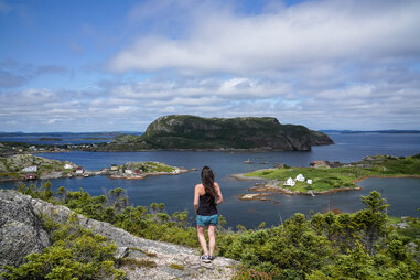 woman overlooking water in newfoundland canada