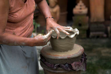 cham woman working wet clay in vietnam