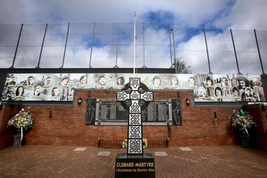 A photograph taken on March 16, 2023, in west Belfast, shows the Republican side of the Peace wall with a memorial for the IRA volunteers who died.