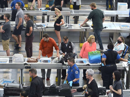Airplane passengers proceed through the TSA security checkpoint at Denver International Airport in Denver, Colorado.