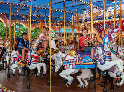 Children riding the carousel ride at Walt Disney World’s Magic Kingdom amusement park.