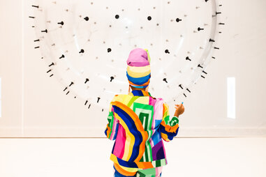 woman touches balloon art at miami balloon museum