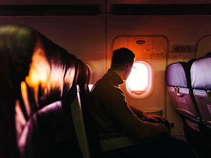 Passenger in the airplane looking at the window