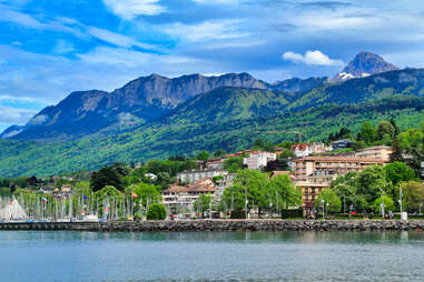 a beautiful french town on water by mountains 