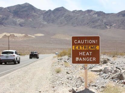 T - A heat advisory sign is shown along US highway 190 during a heat wave in Death Valley National Park in Death Valley, California, on July 16, 2023.