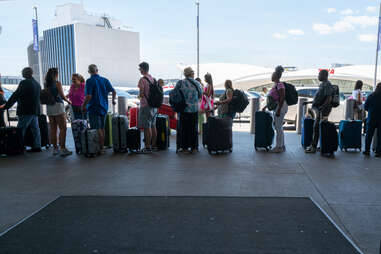 People move through a crowded JFK International Airport