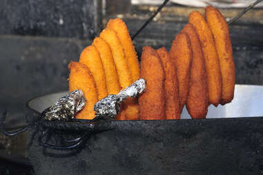 Deep fried alcapurrias hanging to cool in Puerto Rico