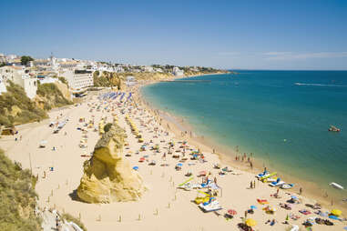 Wide sandy beach in white city of Albufeira, Algarve, Portugal