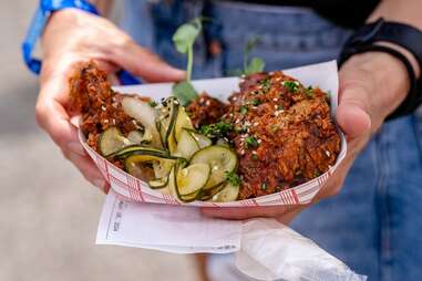 holding a plate of bbq at hogs for the cause