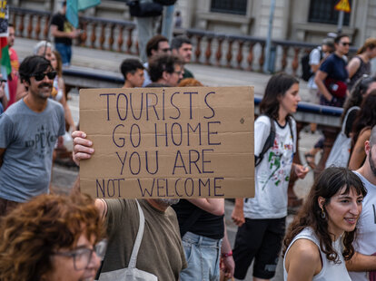 An anti-tourism placard is seen during the demonstration. More than 3,000 people demonstrated against the tourist overcrowding suffered by the city of Barcelona and in favor of tourism reduction policies.