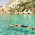 Woman in swimwear enjoying at beautiful turquoise colored water on tropical beach. 