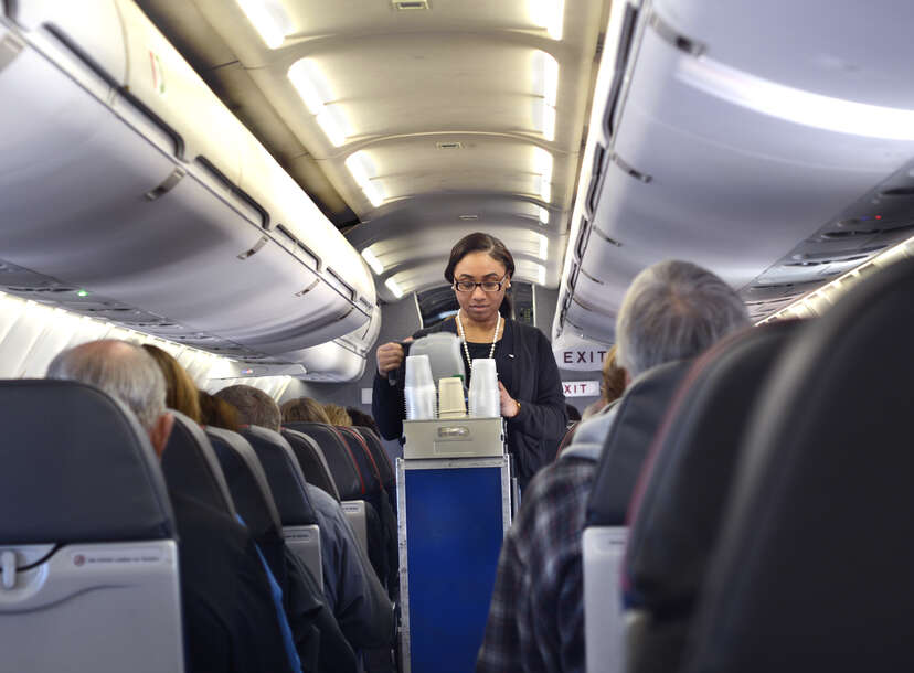 An American Airlines flight attendant serves drinks to passengers after departing from San Antonio International Airport in Texas.