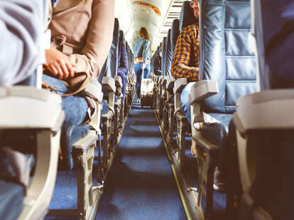 Airplane interior with people sitting on seats