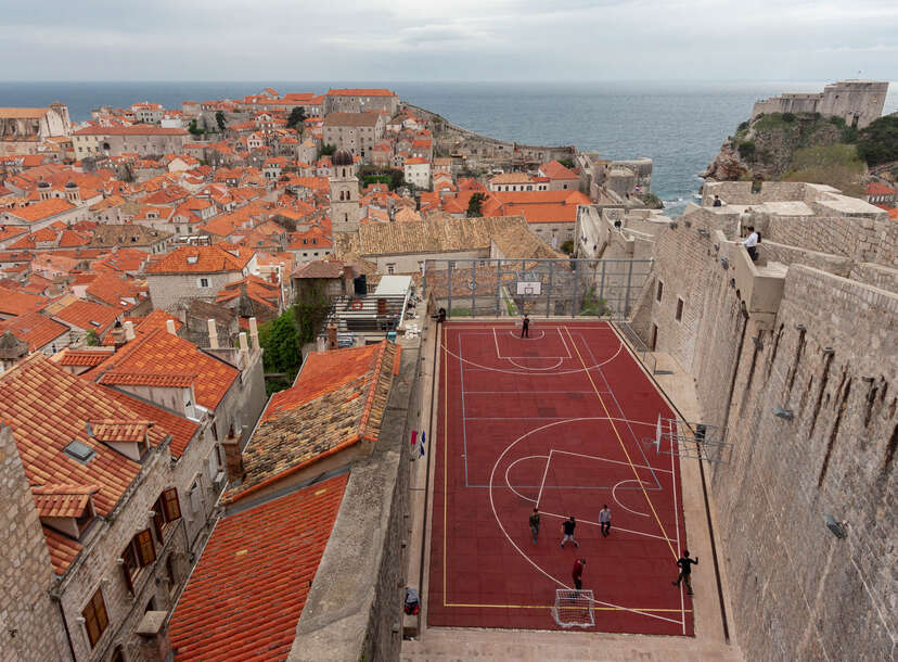 Old City Walls in Croatia overlooking a basketball court.