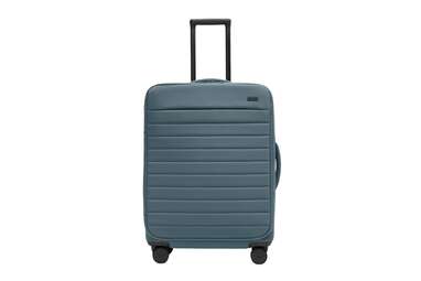 A medium sized cobalt blue Away soft-sided suitcase, 