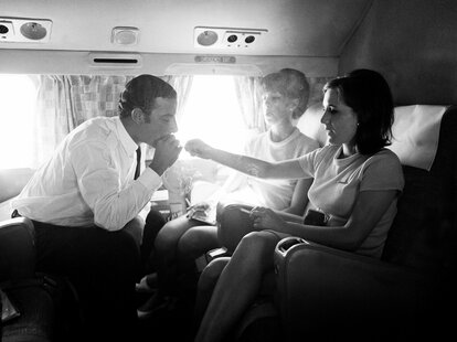 Member of a LAN Airways flight crew take a cigarette break during a flight, 1960s.