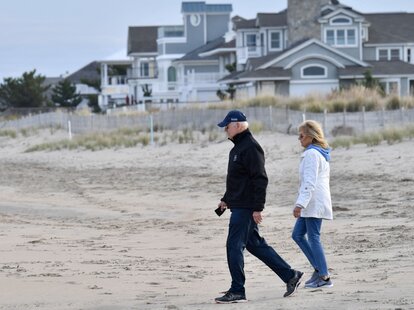 US President Joe Biden and First Lady Jill Biden walk on Rehoboth Beach, Delaware