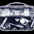 Vanity case with contents, X-ray, showing an interior that contains a vibrator. 