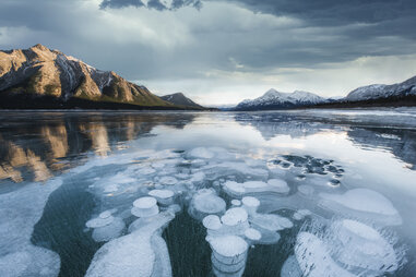 methane bubbles under the surface of a frozen lake