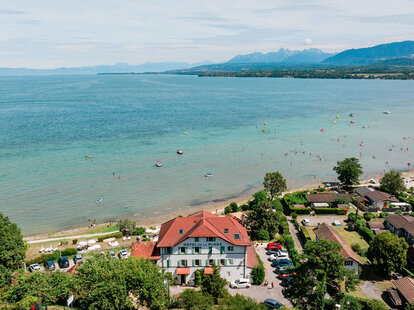 a hotel with green piping on a beach
