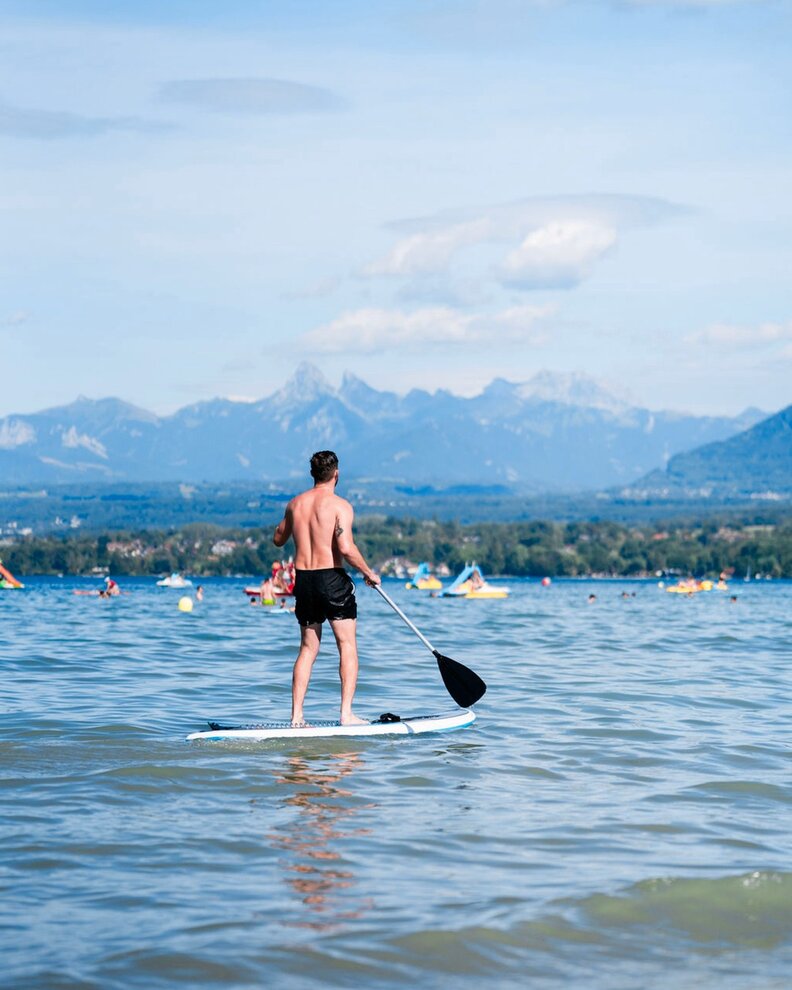 a man paddleboarding in the water on Lake Geneva
