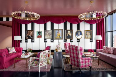 A hotel rooftop bar covered in pink decor.