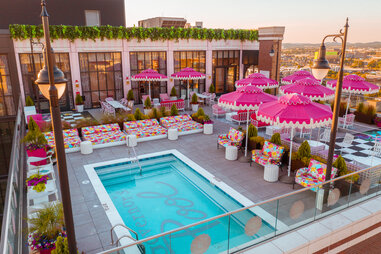 A hotel rooftop bar covered in pink decor.