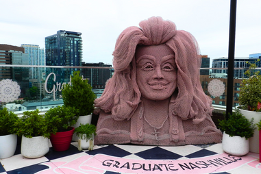 A hotel rooftop bar with a statue of Dolly Parton.