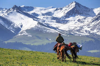 A Kazakh man riding horse on Kalajun grassland