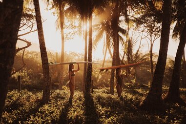 two people with surfboards