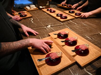 Chefs serve a creation called “Tongue kiss”, rhubarb and elderflower gazpacho, at the Alchemist restaurant in Copenhagen, Denmark, on May 25, 2023