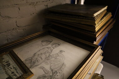 paintings stacked in basement of saslik restaurant helsinki