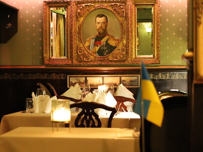saslik restaurant dining room with painting and ukrainian flag