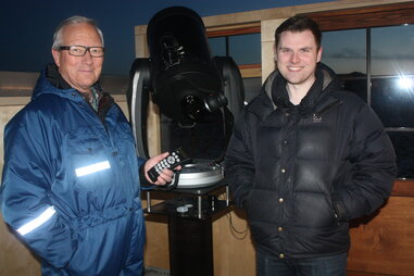 Sævar Helgi Bragason and another man next to a telescope