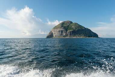 a big rock coming out of the sea 