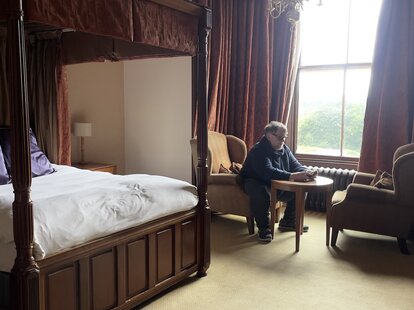 Guillermo del Toro sitting in a haunted hotel room.