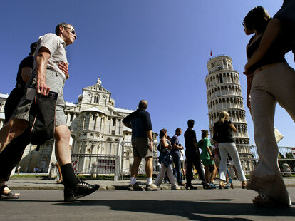 Tourists visit the Leaning Tower of Pisa and the Cathedral in the “Square of Miracle” August 24, 2002 in Pisa, Italy.