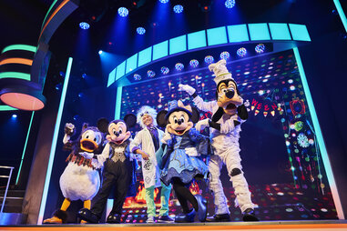 disney characters mickey mouse and friends on stage at disneyland