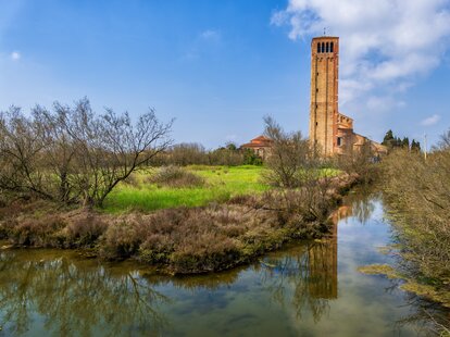 marsh in venetian lagoon with tower in the background