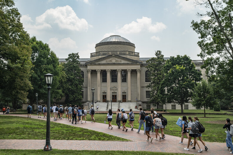 People walk on the campus of the University of North Carolina Chapel Hill