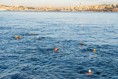 swimmers in the bosphorus strait from above