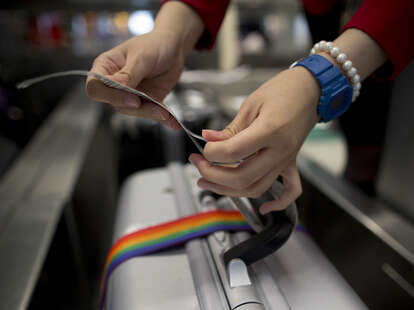 attaching luggage tag at the airport