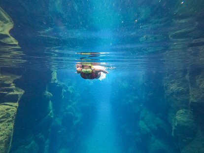 A tourist swims at Las Grietas on Santa Cruz Island, part of the Galapagos Archipelago in Ecuador, on June 26, 2023.