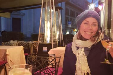 woman drinking wine outdoor cafe with heater