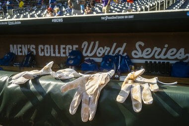 Batting gloves are seen on the rail to the Florida Gators dugout at the College World Series 2023 in Omaha