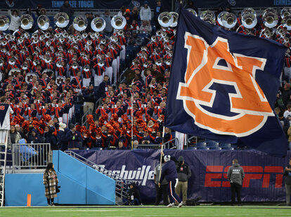 The Auburn Tigers flag is run through the end zone as the band plays during the TransPerfect Music City Bowl between the Auburn Tigers and Maryland Terrapins