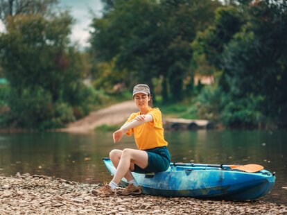 woman kayaking with mosquitos